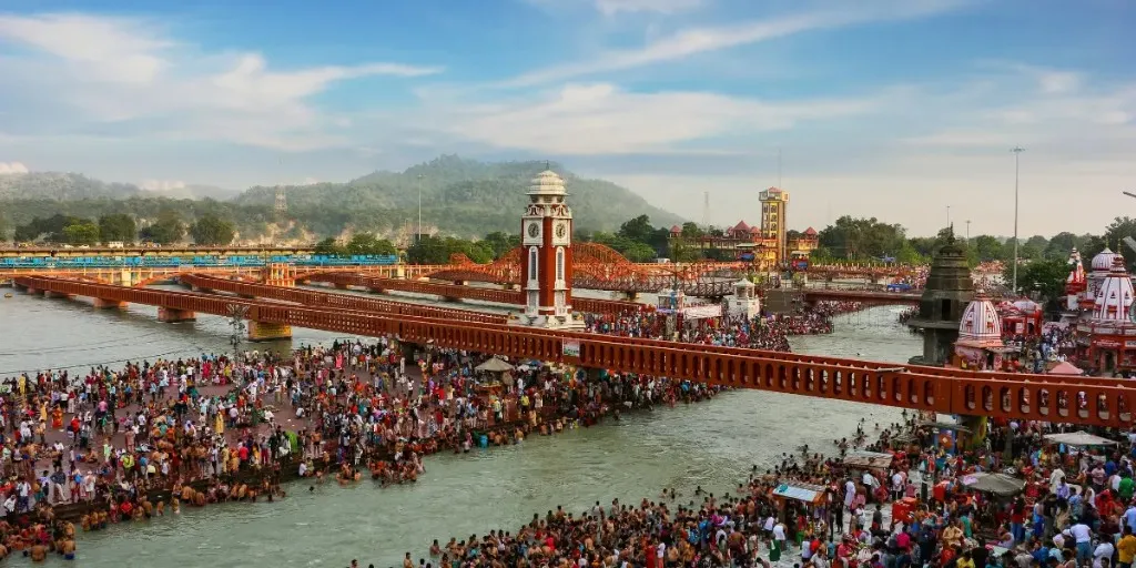 Pilgrims bathing at Har Ki Pauri below the clock tower in Haridwar on a snan day